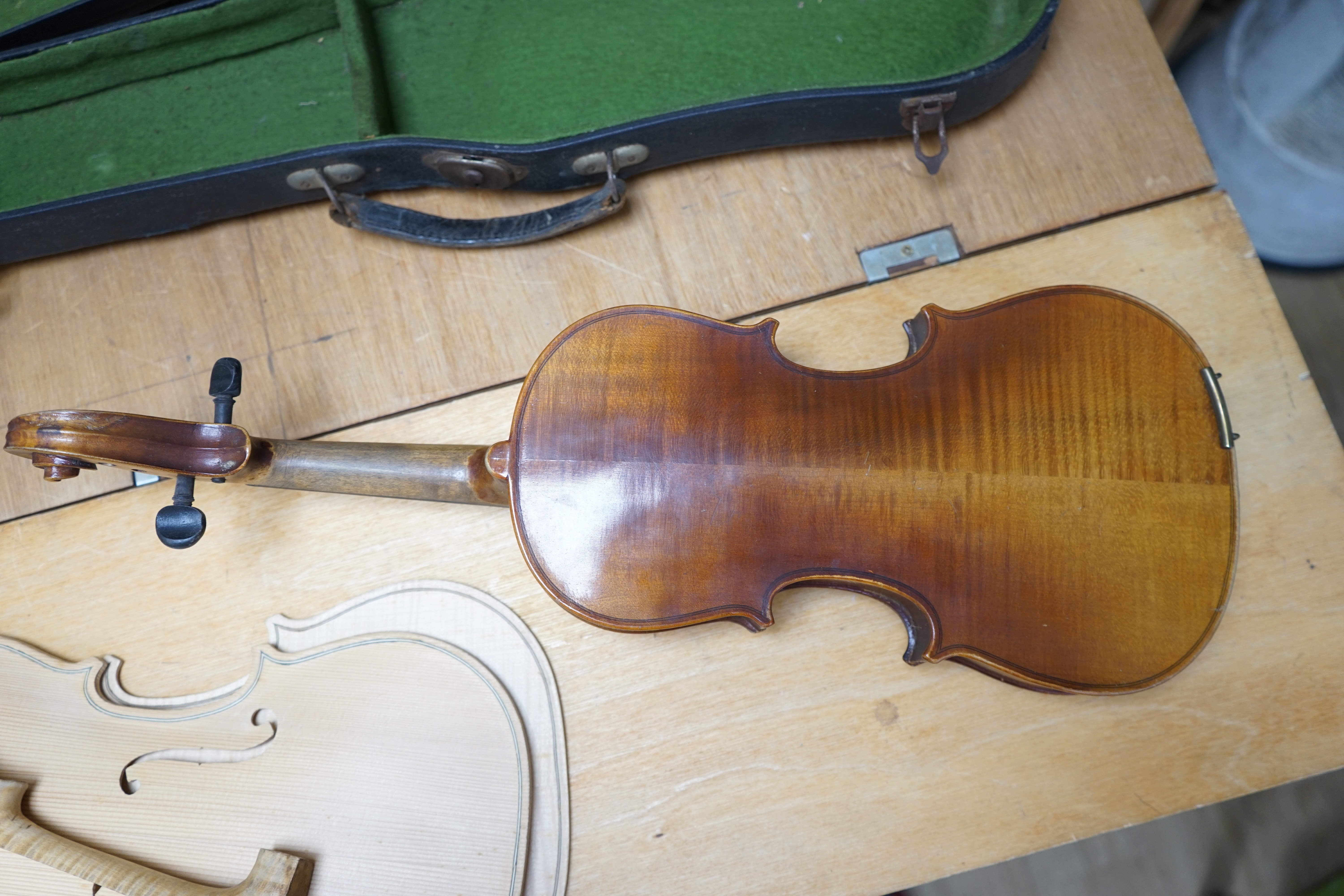 Early 20th century ¾ size violin, unlabelled, cased, together with a violin table, back and scroll. Condition - fair